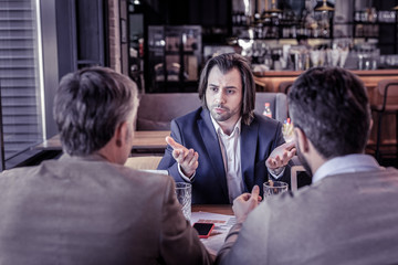 Emotional male person gesticulating during business talk