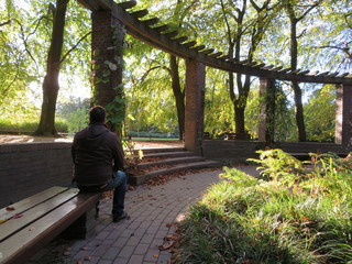 men sitting on a bench in  a park