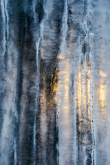 beautiful ice texture lit from behind. ice and sun, cold and warm, winter and spring resistance concept