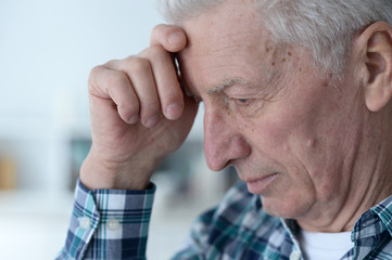 Obraz premium Portrait of thoughtful senior man at home