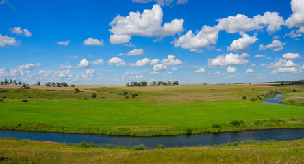 Obraz premium Sunny summer landscape with fields,bending river and beautiful woods.