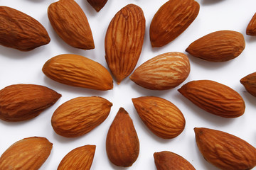 pattern from almonds seeds on a white background