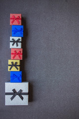 Fototapeta premium A stack of gift boxes on silver shiny background.