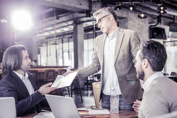 Competent manager working in team with colleagues