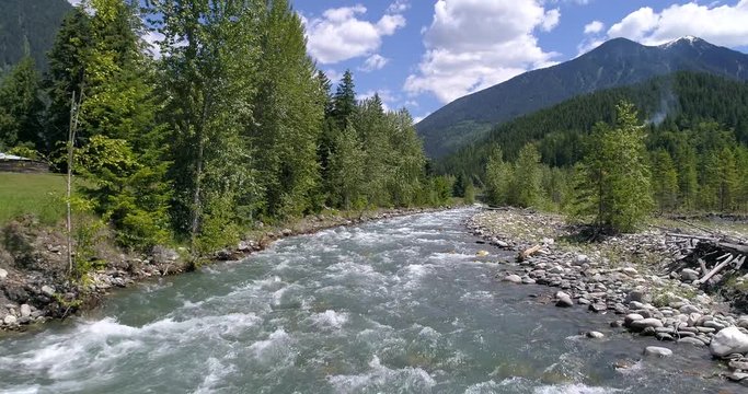 Majestic mountain river in Devis Creek, Vancouver, Canada. Drone flying. Aerial view with mountain background.