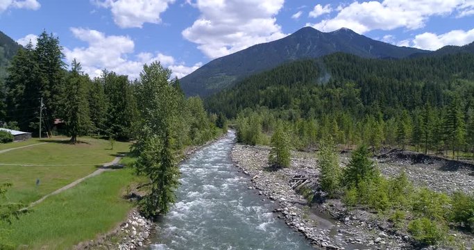 Majestic mountain river in Devis Creek, Vancouver, Canada. Drone flying. Aerial view with mountain background.