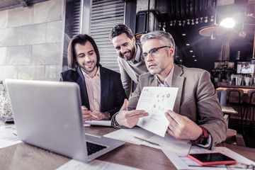 Serious businessman pointing at diagram of project