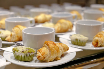 Row of coffee cup and cupcake, Croissant set for break seminar or meeting