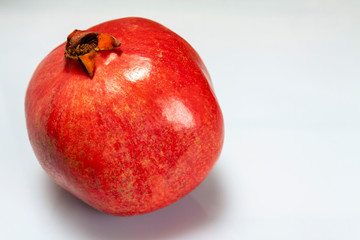 Ripe big pomegranate on a white background, isolate.