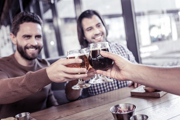 Positive delighted males having rest after work