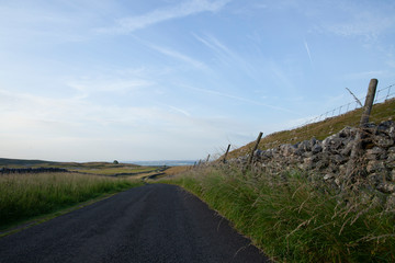 Road and Dry Stone Wall in the Yorkshire Dales National Park - 233582500