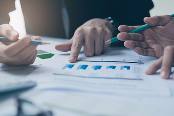 Close up hand of marketing pointing at business document at meeting room.