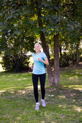 Senior woman doing exercise in the green park