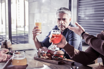 Sad mature man communicating with his friends