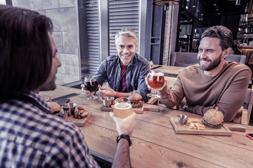 Friendly males sitting in cafe during break