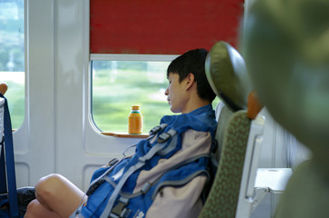 Portrait Asian man napping during traveling by train.