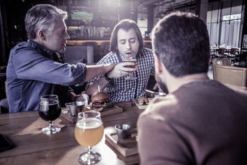 Serious mature man helping his young friend