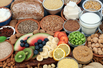 Health food for vegans with almond butter, yoghurt & milk, tofu bean curd, grains, seeds, nuts,...