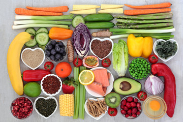 Healthy food for fitness concept with fresh seafood,  fruit, vegetables, herbs, spices, seeds, dairy, pasta, green tea and grain. High in antioxidants, anthocyanins, vitamins and dietary fibre.  