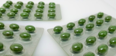 Green pills in the pharmacy laboratory