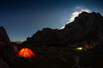 Fototapeta na wymiar starry night sky high in the mountains and a tent