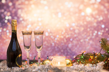 New years eve celebration background with champagne and a pair of glasses with christmas decoration. Party and celebration concept.