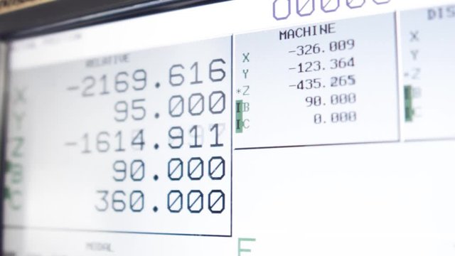 Сnc machine monitor. Display with program code running and numbers with parameters changing.