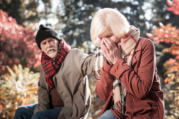 Fototapeta premium Depressed crying aged woman covering her face