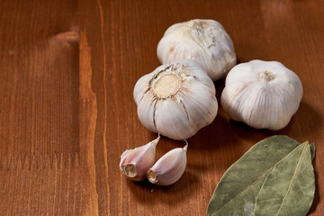 Garlic and garlic cloves on wooden background. Selective focus