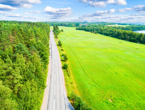 Aerial View Of A Country Road In The Forest With Moving Cars. Landscape. Captured From Above With A Drone. Aerial Bird's Eye Road With Car. Aerial Top View Forest. Texture Of Forest View From Above.