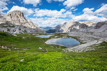 Beautiful mountainscape with cloudy sky and two small mountain lakes. Tre Cime di Lavaredo National park, Dolomites, Italy.