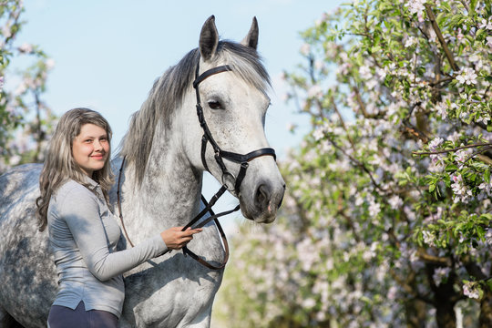 Happy young lady with a horse.