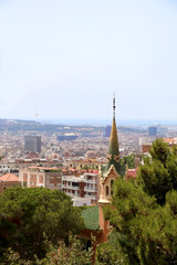 View of Barcelona from Park Güell with The Gaudi House Museum in the foreground.