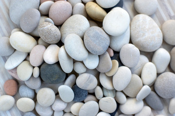 Fototapeta na wymiar Group of white, grey and black pebbles, one by ony, simplicity stone background