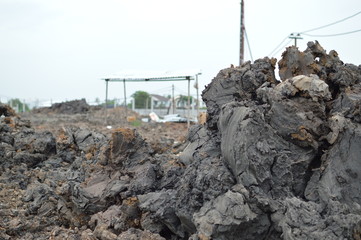 close up wet clod clay soil at the construction site or field, construction site background.