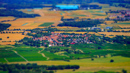 Beautiful tilt-shift aerial view to the colorful valley from the top of the hill