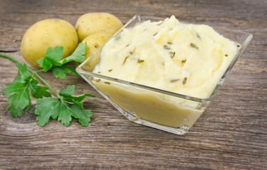 Mashed potatoes on wooden table