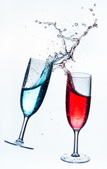 Colorful splash in champagne glass isolated on white background