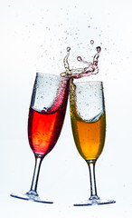 Colorful splash in champagne glass isolated on white background