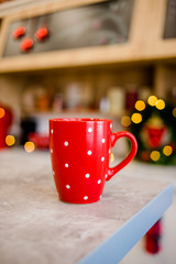 The red cup is on the table