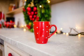 The red cup is on the table