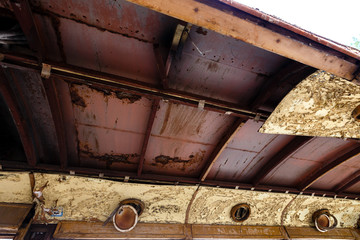 Old rusty wagon of destroyed tram outdoors.
