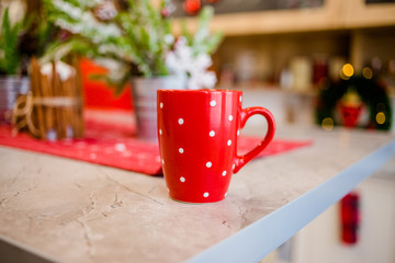 The bright red cup stands on the table