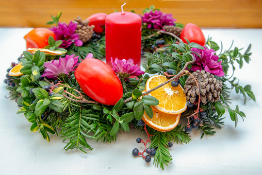Unique handmade magic Christmas wreath with a red candle and red bell peppers - Powered by Adobe