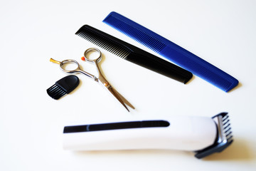Scissors and two combs . Hair clippers and comb isolated on white background.