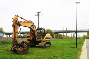 excavator standing on side of a road