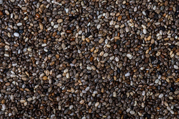 Healthy chia seeds on the table close-up, top view