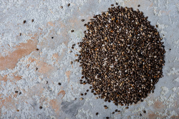 Healthy chia seeds on the table close-up, top view