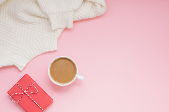 coffee sweater and red present pink background