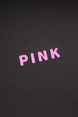 Pink writing on black paper background